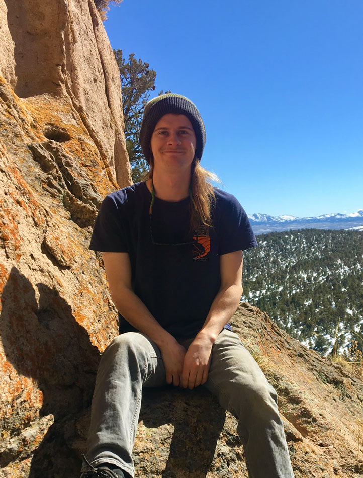 Andrew Christoforo sitting on rock